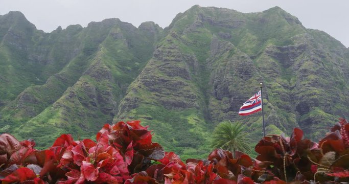 Hawaii nature landscape with Kualoa Mountain range and Hawaiian Flag on Oahu, Hawaii, USA.