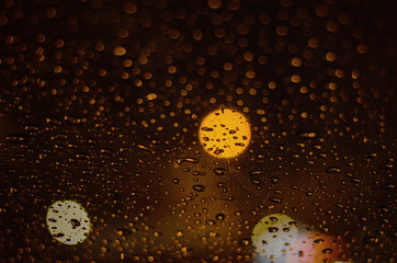 Rain drops on windows with abstract lights