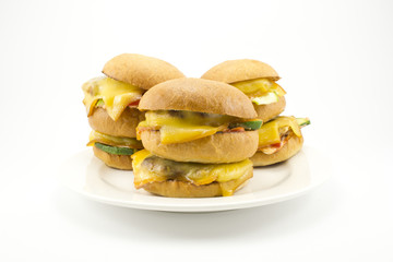 three juicy burgers after homemade cooking cool on a plate.