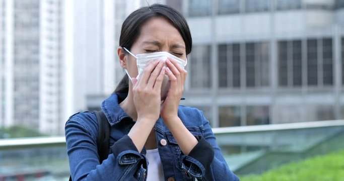 Woman sneeze and cough on face mask - Powered by Adobe