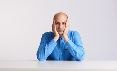Worried man sits at the desk