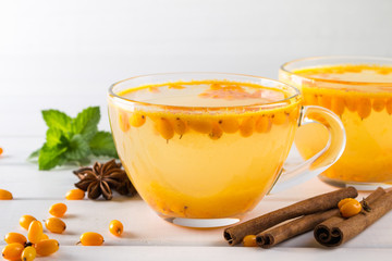 Natural Berry tea with a fresh sea-buckthorn berries and cinnamon sticks, anise stars