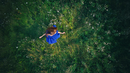 Fototapeta na wymiar woman on a green grass. Top view