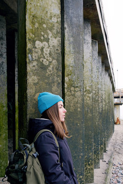Lady in front of row of square columns.