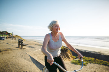 Vibrant mature woman enjoying herself on a bicycle