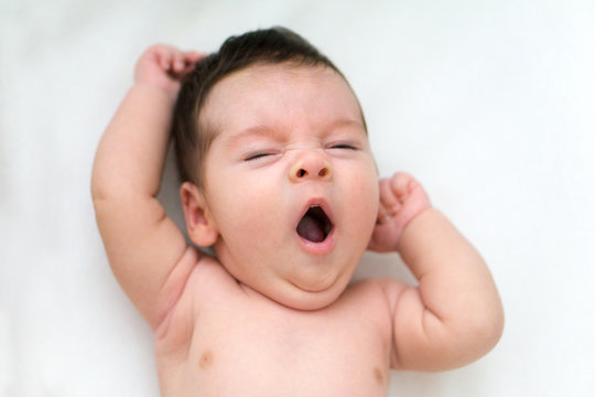Baby stretching in bed