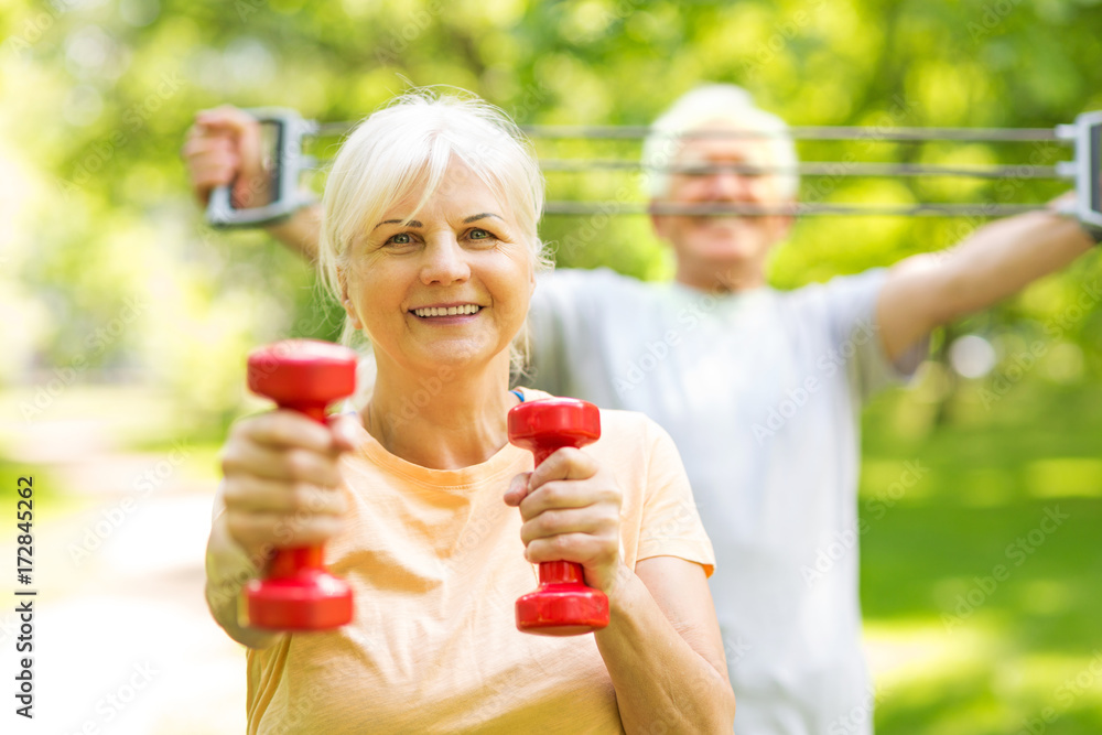 Poster senior couple exercising in park