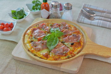 Salame pizza on wooden plate cutting board style