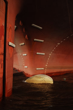 Prow of an old red freighter at wharf