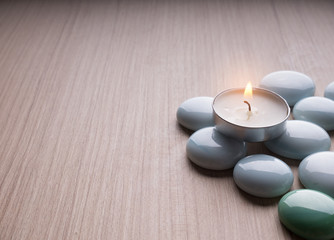 Spa still life concept,Close up of spa theme on wood background with burning candle and bamboo leaf and flower