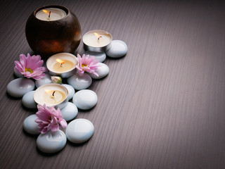 Obraz na płótnie Canvas Spa still life concept,Close up of spa theme on wood background with burning candle and bamboo leaf and flower