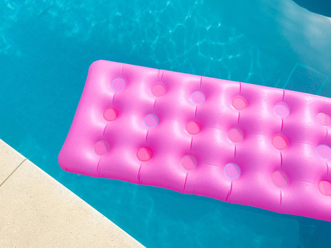 Bright Pink Lilo In Swimming Pool