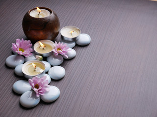 Spa still life concept,Close up of spa theme on wood background with burning candle and bamboo leaf and flower