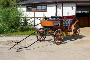 a wooden vintage cart, a carriage for walking with horses