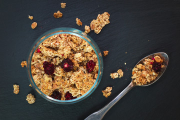Food breakfast concept Organic Muesli or Granola on black slate stone plate