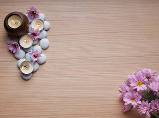 Spa still life concept,Close up of spa theme on wood background with burning candle and bamboo leaf and flower