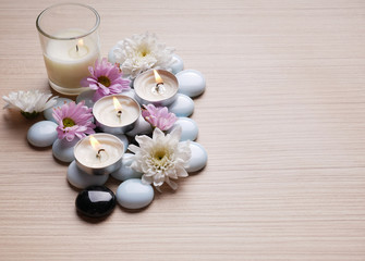 Fototapeta na wymiar Spa still life concept,Close up of spa theme on wood background with burning candle and bamboo leaf and flower