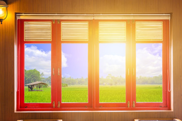 Fototapeta premium wood windows with nature rice field outside clipping path of glass panel.