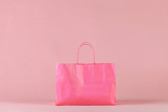 Pink shopping bag on pink background