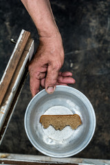 In his hand clamped plate. The plate is a piece of bread.
