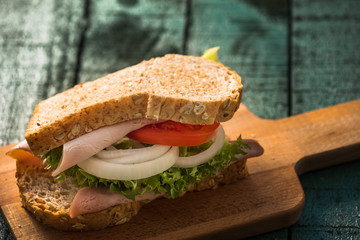 club sandwich on green wood