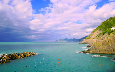 Naklejka premium Lovely weather in the morning at an empty deep blue Mediterranean sea with cliffs on the side