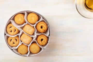Overhead view of Danish butter cookies with tea and copyspace