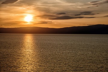 Beautiful sunset above the sea and mountain