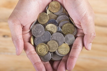 Close up of Coins in hand. Concept of saving or invest.