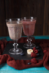 Photo of two glasses with smoothies on table with cloth