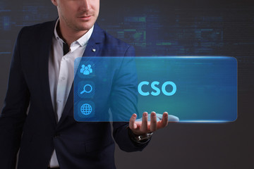 Business, Technology, Internet and network concept. Young businessman working on a virtual screen of the future and sees the inscription: CSO