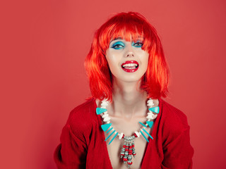 Girl smiling with bright artificial hair in ethnic jewelry.