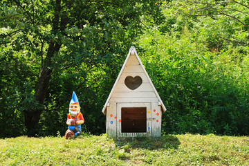 Small white dog house and a colorful dwarf