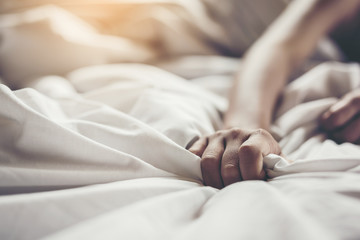 woman sit on a bed in a bedroom - concept photo of Sexual assault.,Woman violence concept.