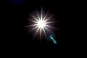 Solar lens flare on black background