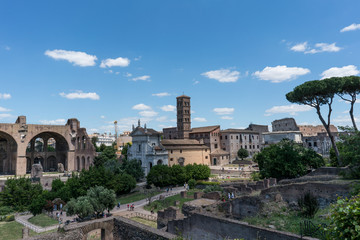Fototapeta na wymiar Panoramic view of the ruins of the forum of the time of the Roman Empire, with tourists visiting it