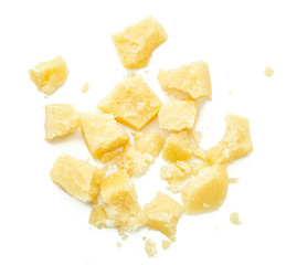 Parmesan cheese pieces on white background. Italian cheese slices. Top view.