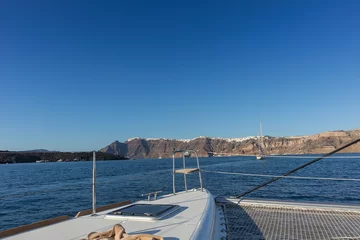 Rolgordijnen Catamaran deck overlooking santorini. © silvapinto