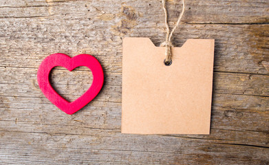 Heart shape and empty card on wooden background