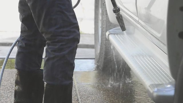 Car cleaning ,cleaning service concept.
Worker cleaning side ladder of pick up car with high pressure washer,HD slow motion.
