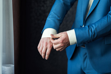 Obraz premium Businessman wears a jacket.Politician, man's style,male hands closeup, American, European businessman, business, fashion and clothing concept