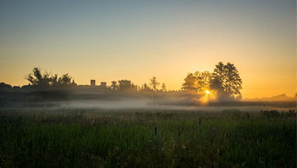 Fototapeta premium Sunrise during the fog over the castle in Czersk, Poland