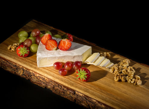 Brie cheese on a chopping board.