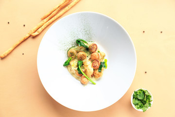 Small meat balls on green plate, fresh special spices for meat balls herbs thyme, coriander, basil, rosemary, cherry tomatoes, silver fork on light white wooden background, rustic style