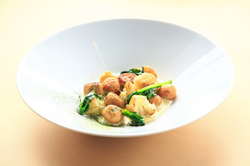 Small meat balls on green plate, fresh special spices for meat balls herbs thyme, coriander, basil, rosemary, cherry tomatoes, silver fork on light white wooden background, rustic style