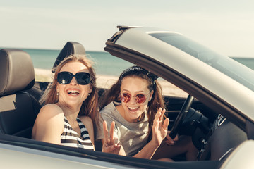 Happy friends in car