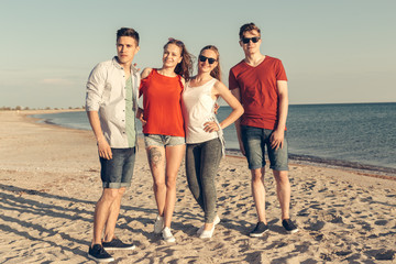 Group of young people enjoy summer party at the beach