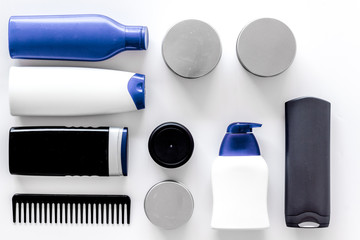 Shampoo and shower gel for men on white background top view