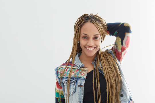 Young African American female  with long  braids on white background