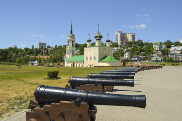 Fototapeta na wymiar antique ship cannons on the background of the Uspensky (Admiralty) temple. Admiralteysky square, Voronezh city, Russia Federation, 14 Aug 2017